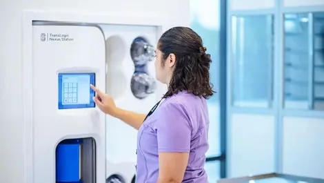 Nurse using translogic nexus station touchscreen